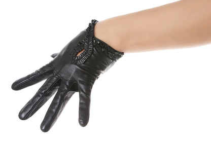 A black leather glove with decorative ruffle trim shown worn on a person's hand against a plain white background.