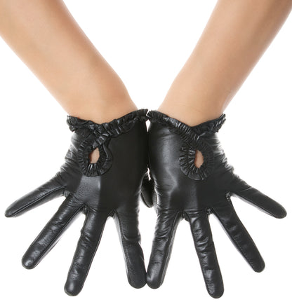 Black leather gloves with ruffled cuffs and cutout details on the back of the hand, shown on a model's hands against a white background.