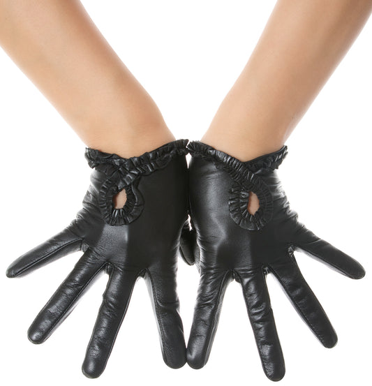 Black leather gloves with ruffled cuffs and cutout details on the back of the hand, shown on a model's hands against a white background.