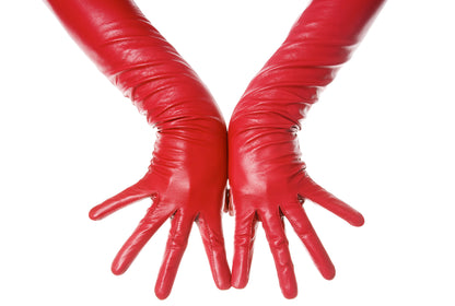 Close up  of a pair of red opera leather gloves worn by model 